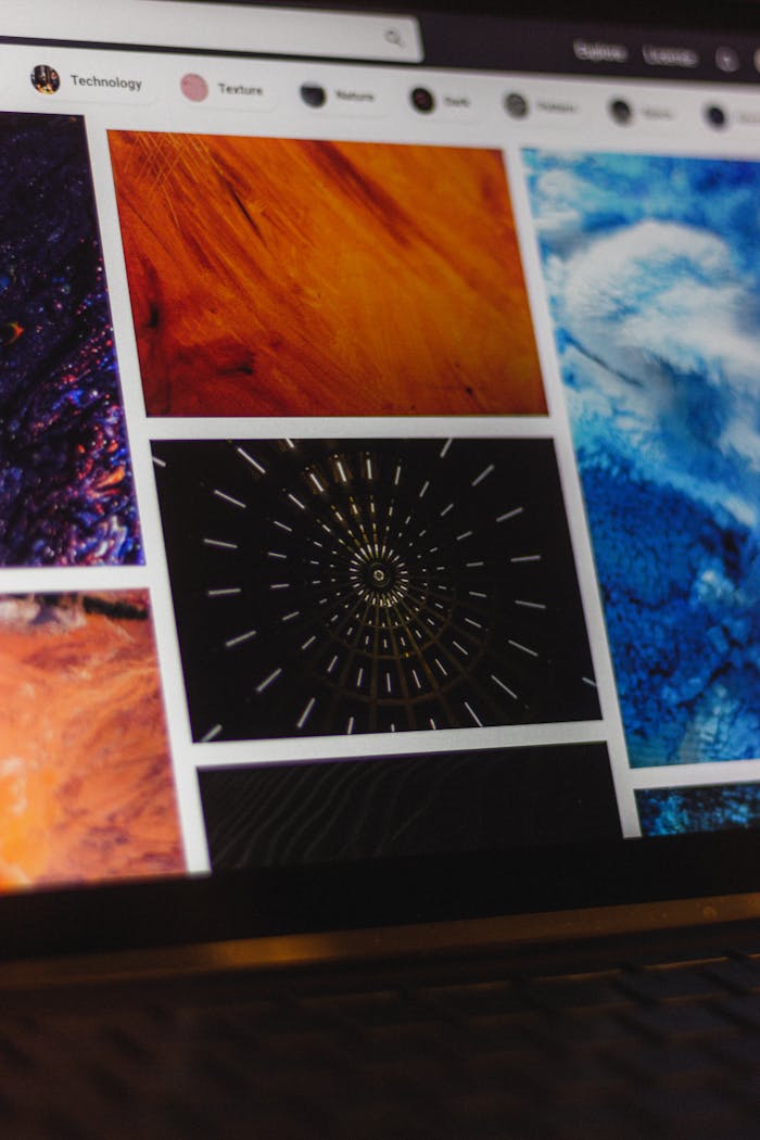 Portable computer with website representing assorted abstract photos under favorites and browser search engine with magnifier symbol